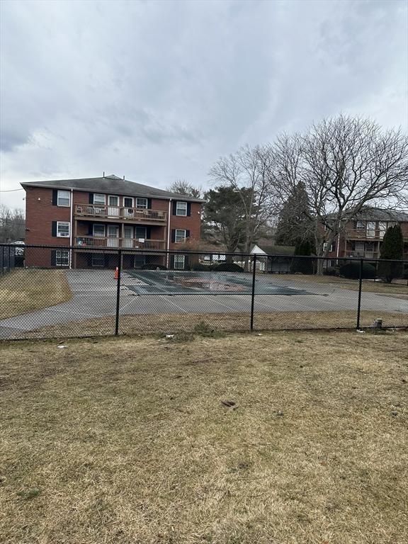 exterior space with fence and a yard