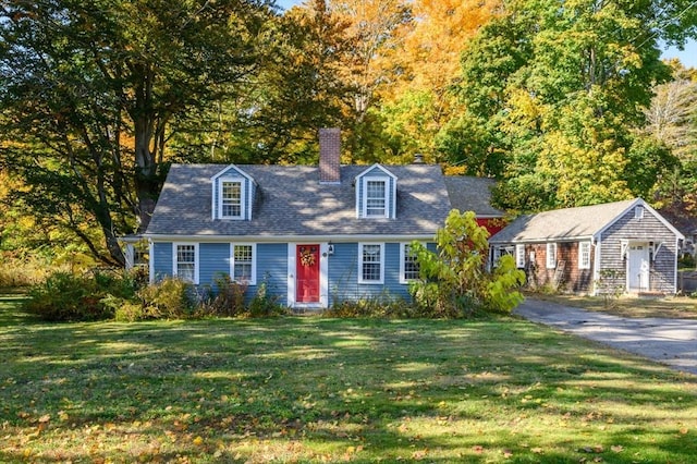 cape cod home with a front yard