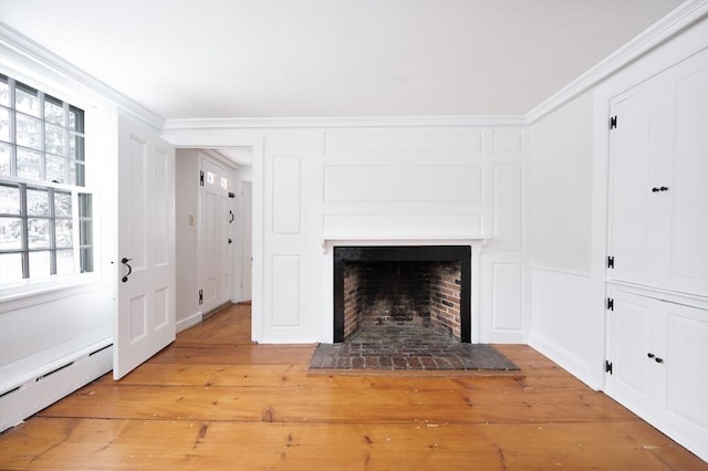 details with wood-type flooring, a baseboard radiator, a brick fireplace, and crown molding