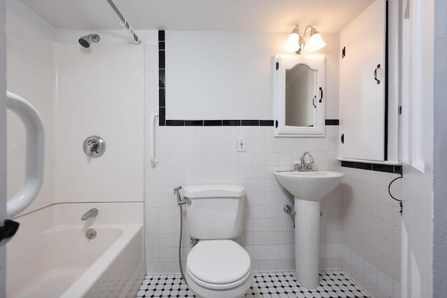 full bathroom featuring tile patterned floors, tile walls, sink,  shower combination, and toilet