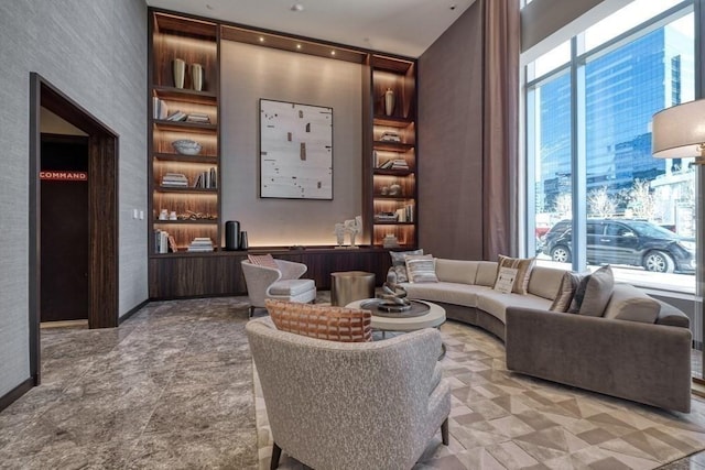 living room with a wealth of natural light and baseboards