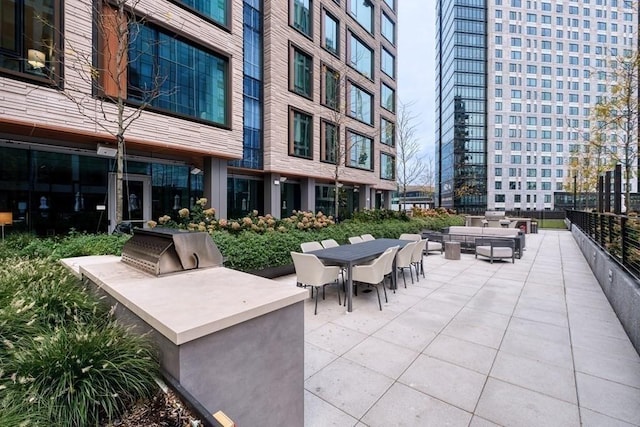 view of patio / terrace featuring area for grilling and outdoor dining area