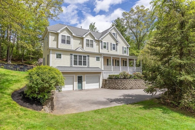 back of house with asphalt driveway and an attached garage