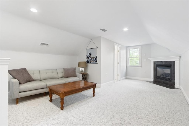 carpeted living room with lofted ceiling, a fireplace, baseboards, and recessed lighting