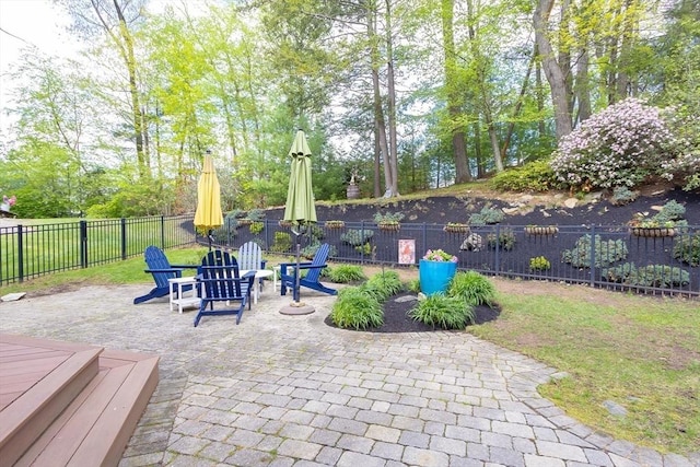 view of patio featuring a fenced backyard and view of scattered trees
