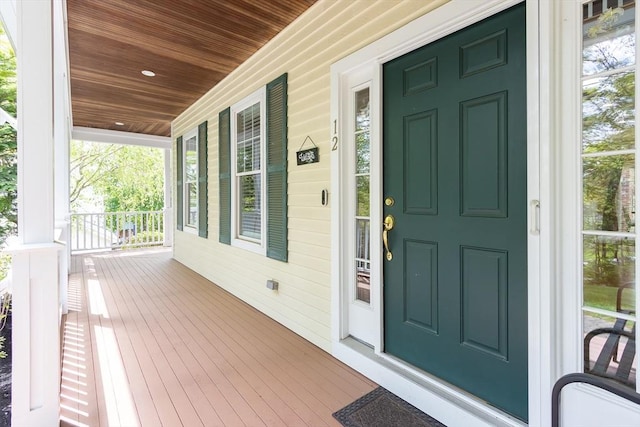 view of exterior entry with a porch