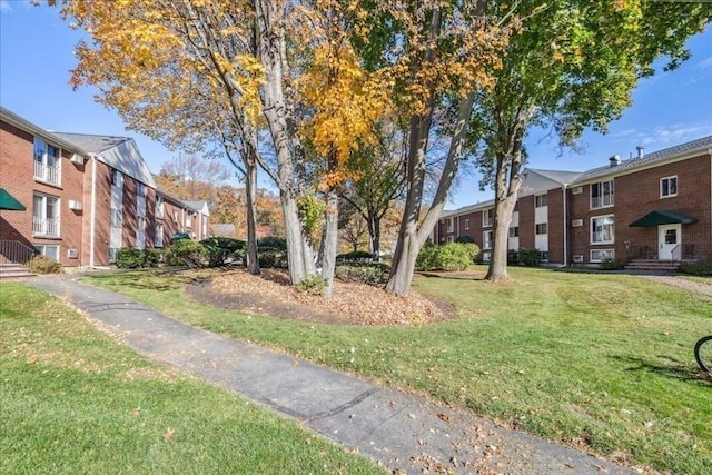 view of home's community with a yard