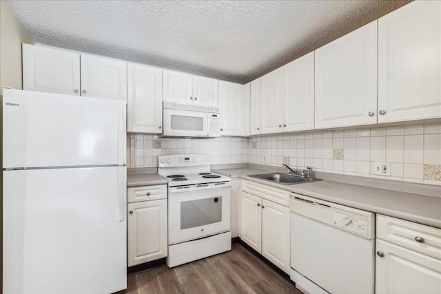 kitchen featuring a textured ceiling, white cabinetry, white appliances, and sink