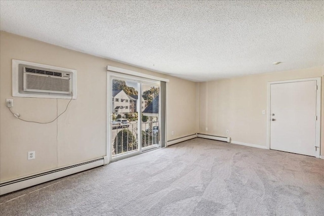 carpeted empty room with a textured ceiling, a wall unit AC, and a baseboard heating unit