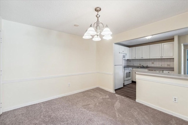 kitchen featuring tasteful backsplash, white appliances, decorative light fixtures, a notable chandelier, and white cabinets