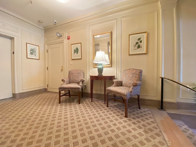 living area featuring crown molding