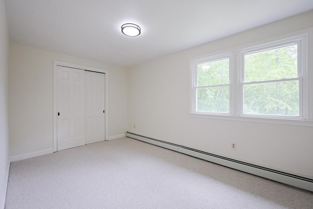 269 Fairview Ave, Rehoboth, MA 02769 - unfurnished bedroom with a baseboard radiator, a closet, and light carpet