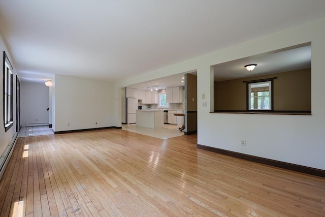 269 Fairview Ave, Rehoboth, MA 02769 - unfurnished living room with light wood-type flooring, plenty of natural light, and a baseboard radiator