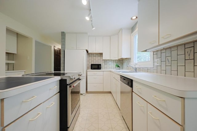 269 Fairview Ave, Rehoboth, MA 02769 - kitchen featuring appliances with stainless steel finishes, white cabinetry, decorative backsplash, and light countertops
