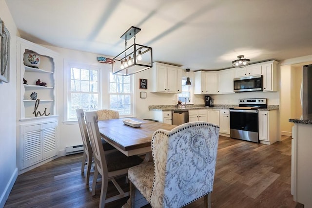 dining area featuring dark wood finished floors, baseboards, and a baseboard heating unit