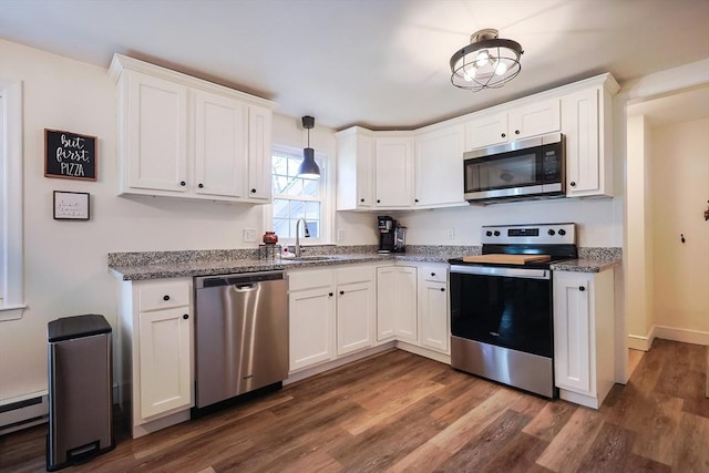 kitchen featuring a sink, dark wood-style flooring, white cabinetry, and stainless steel appliances