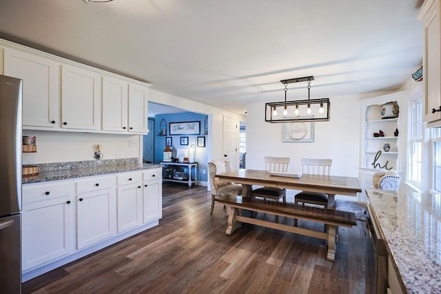 dining area featuring dark wood-style flooring