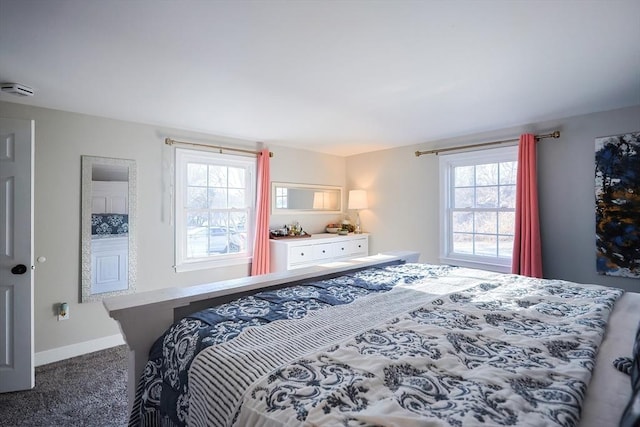 carpeted bedroom featuring baseboards