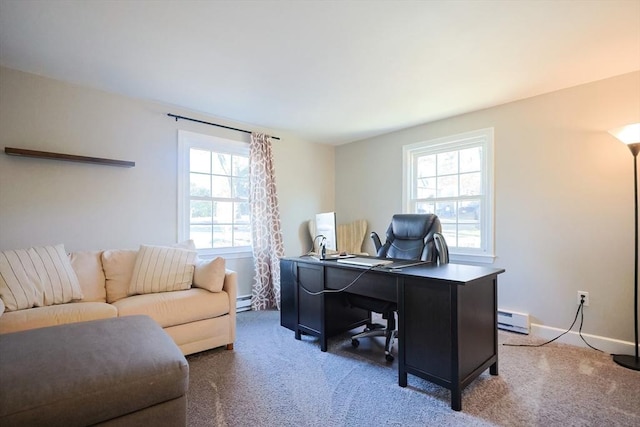 carpeted office space with a baseboard heating unit, baseboards, a healthy amount of sunlight, and a baseboard radiator