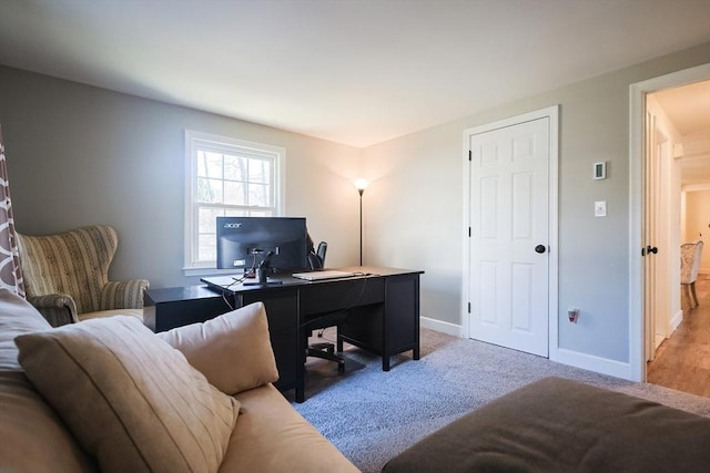 home office with light colored carpet and baseboards