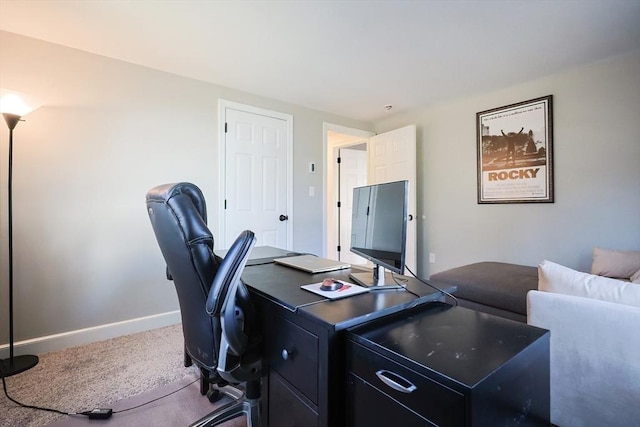 carpeted office featuring baseboards