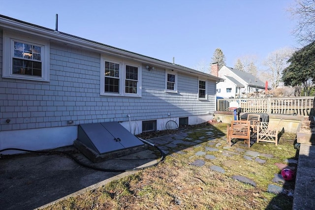 back of house with a chimney