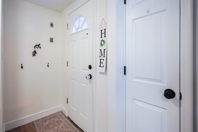 doorway to outside with baseboards and light wood finished floors