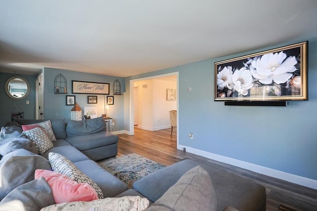 living room featuring baseboards and wood finished floors