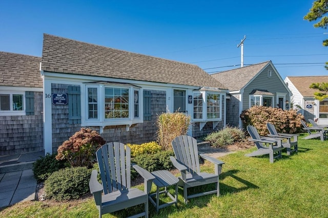 135 S Shore Dr Unit 17, Yarmouth, MA 02664 - back of property with roof with shingles and a lawn