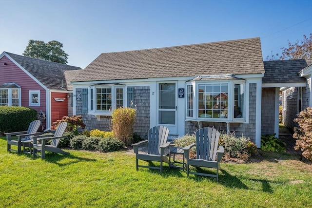 135 S Shore Dr Unit 17, Yarmouth, MA 02664 - rear view of house featuring a shingled roof and a lawn