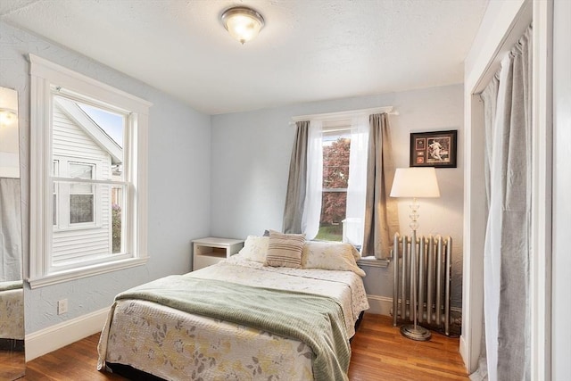 33 Alden Ave, Revere, MA 02151 - bedroom featuring radiator, wood finished floors, and baseboards
