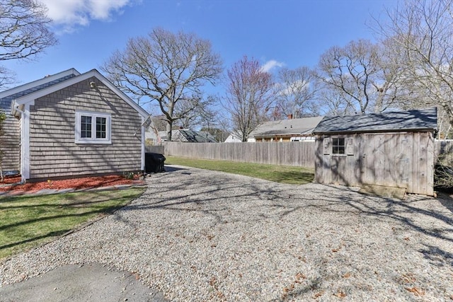 16 Samoset Rd, Yarmouth, MA 02664 - view of property exterior featuring a storage unit, fence, and an outdoor structure