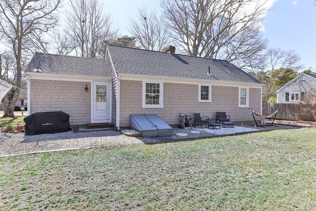 16 Samoset Rd, Yarmouth, MA 02664 - back of house with a yard, a chimney, fence, a patio, and roof with shingles
