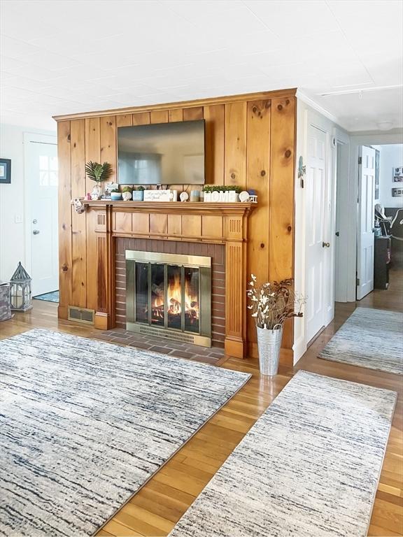 16 Samoset Rd, Yarmouth, MA 02664 - room details with wood finished floors, a brick fireplace, and visible vents
