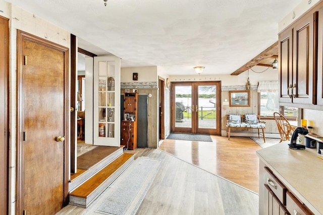 650 Pearse Rd, Swansea, MA 02777 - foyer entrance with french doors, light wood-style flooring, and a baseboard heating unit