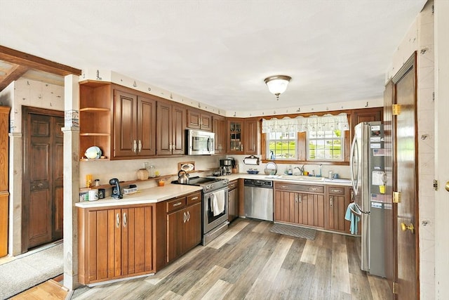 650 Pearse Rd, Swansea, MA 02777 - kitchen featuring stainless steel appliances, light wood-style floors, light countertops, open shelves, and a sink