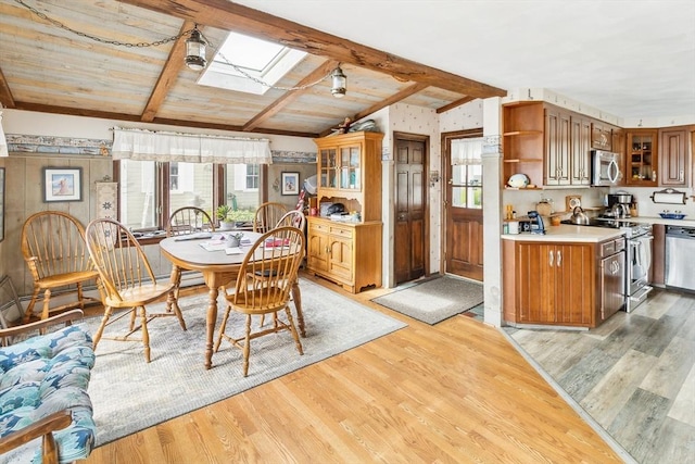 650 Pearse Rd, Swansea, MA 02777 - dining room featuring a skylight, light wood-style flooring, and wood ceiling