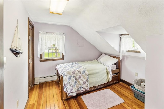 650 Pearse Rd, Swansea, MA 02777 - bedroom featuring a baseboard heating unit, lofted ceiling, and wood-type flooring