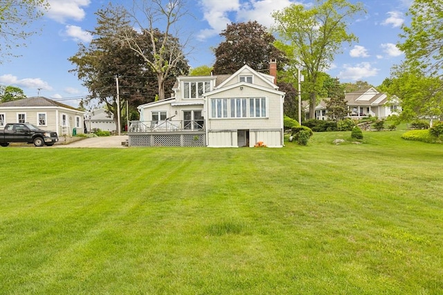 650 Pearse Rd, Swansea, MA 02777 - rear view of house featuring a wooden deck, a chimney, and a lawn
