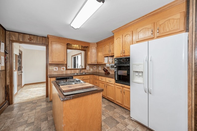 kitchen featuring oven, decorative backsplash, a kitchen island, white fridge with ice dispenser, and sink