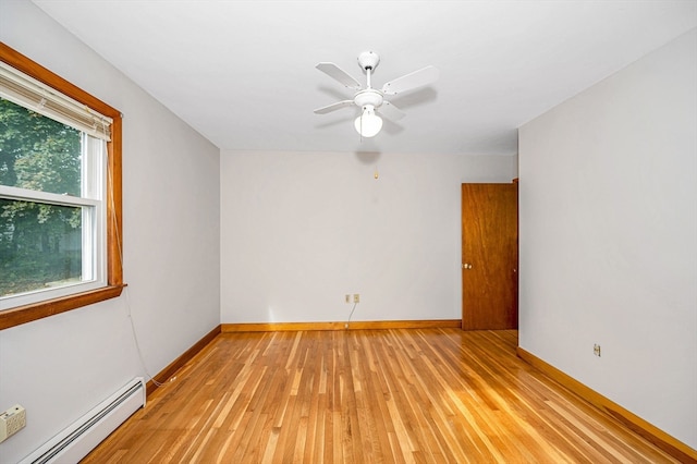 unfurnished room featuring baseboard heating, light wood-type flooring, and ceiling fan