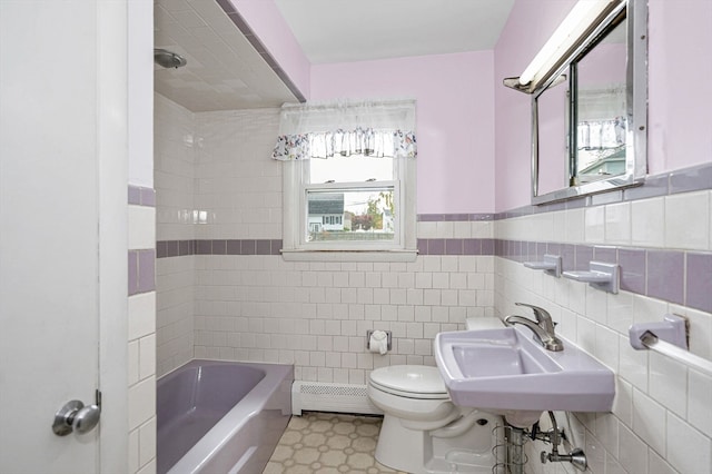 full bathroom featuring toilet, a baseboard radiator, sink, tiled shower / bath combo, and tile walls