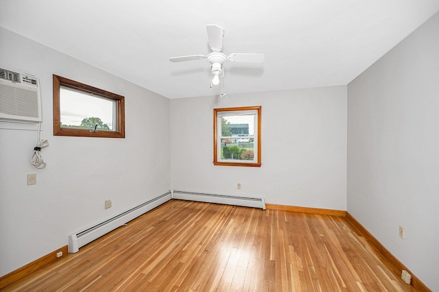 empty room featuring baseboard heating, light hardwood / wood-style flooring, a wall unit AC, and ceiling fan