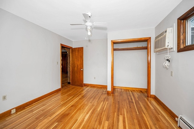 unfurnished bedroom with light hardwood / wood-style flooring, a baseboard heating unit, a closet, and ceiling fan