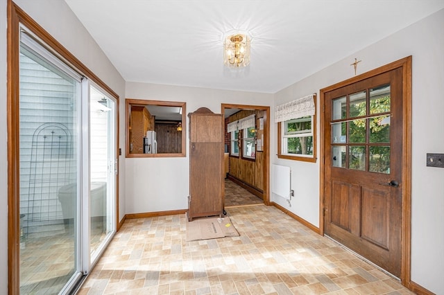 entryway featuring a notable chandelier and radiator heating unit