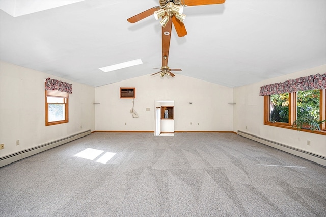 spare room featuring a wealth of natural light, lofted ceiling with skylight, and baseboard heating