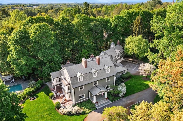 view of subject property featuring a heavily wooded area