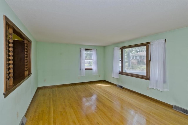 51 Hardy St, Springfield, MA 01129 - empty room with light wood-type flooring, baseboards, and a baseboard heating unit