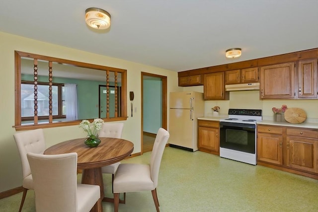 51 Hardy St, Springfield, MA 01129 - kitchen with electric range oven, freestanding refrigerator, under cabinet range hood, light countertops, and brown cabinets