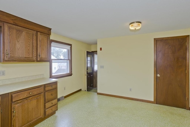 51 Hardy St, Springfield, MA 01129 - kitchen featuring brown cabinets, baseboards, and light countertops